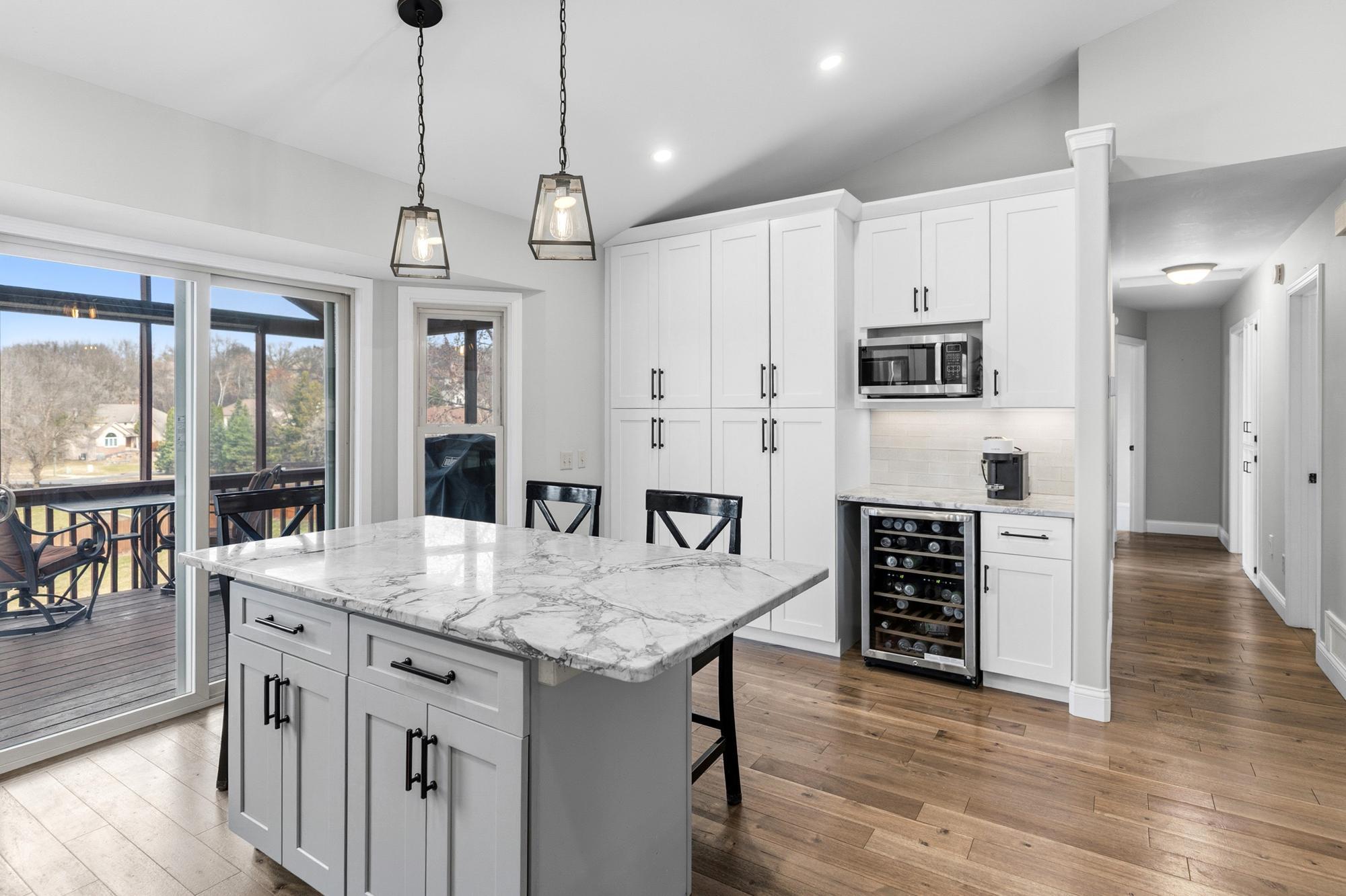 loads of pantry storage and sliding glass doors out onto your screened porch and deck!