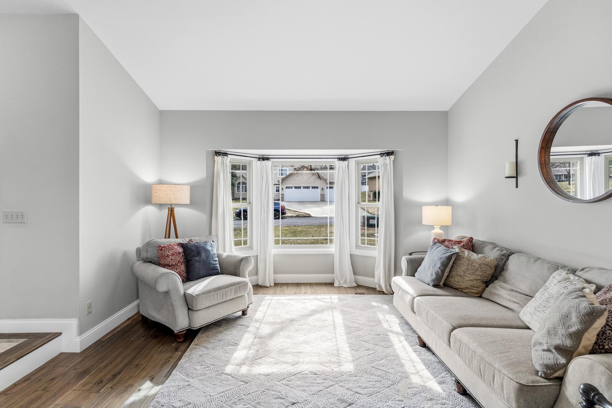 There's plenty of seating space in the generously sized living room. (A baby grand would also look really lovely in the bay window!)