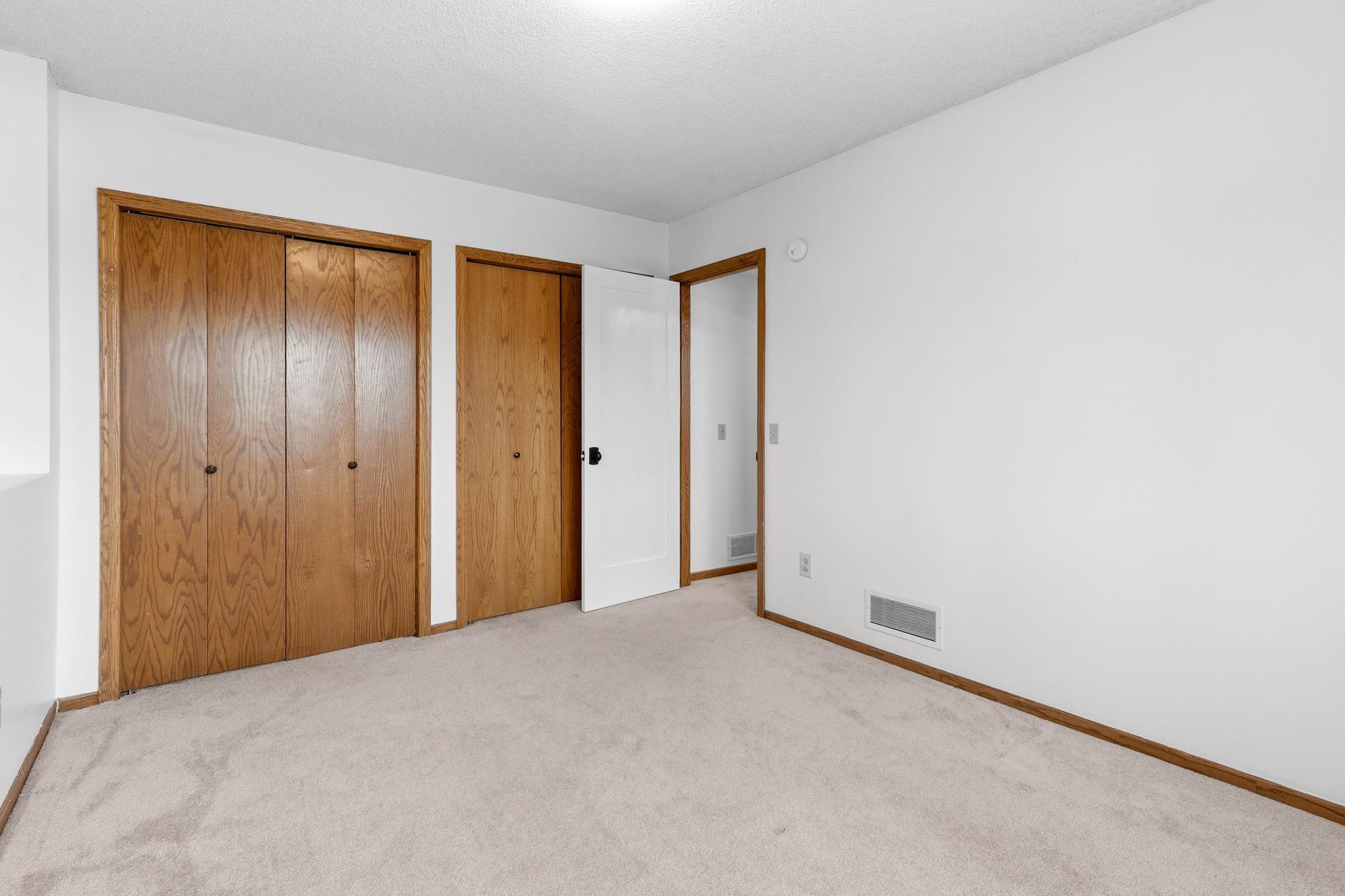 The last bedroom in this home is on the lower level. It is a great space for someone who might want or need a bit more privacy. This room also has double closets.