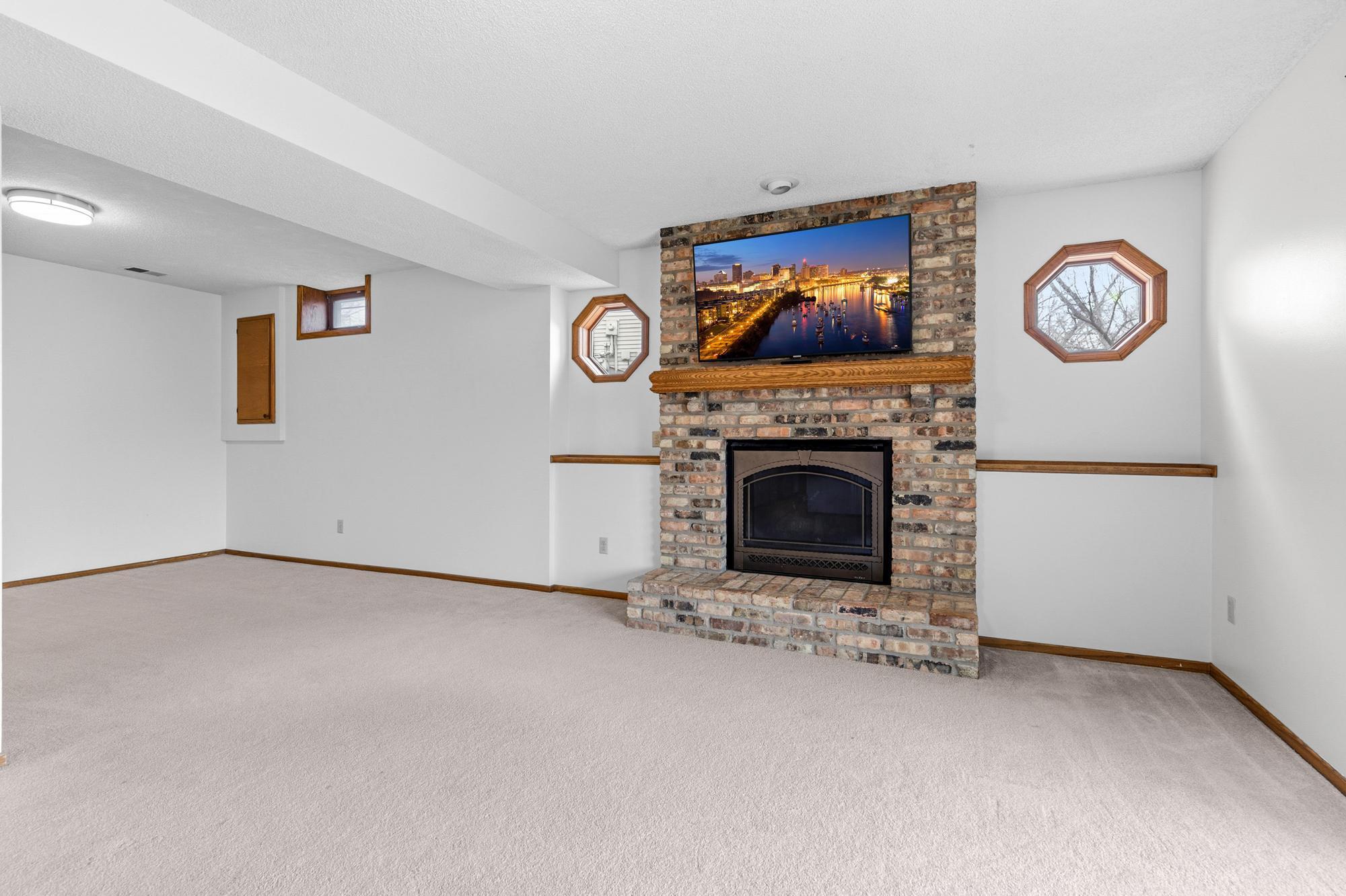 The fireplace is flanked by two fun windows and has a mantle perfectly situated for a large-screened television.