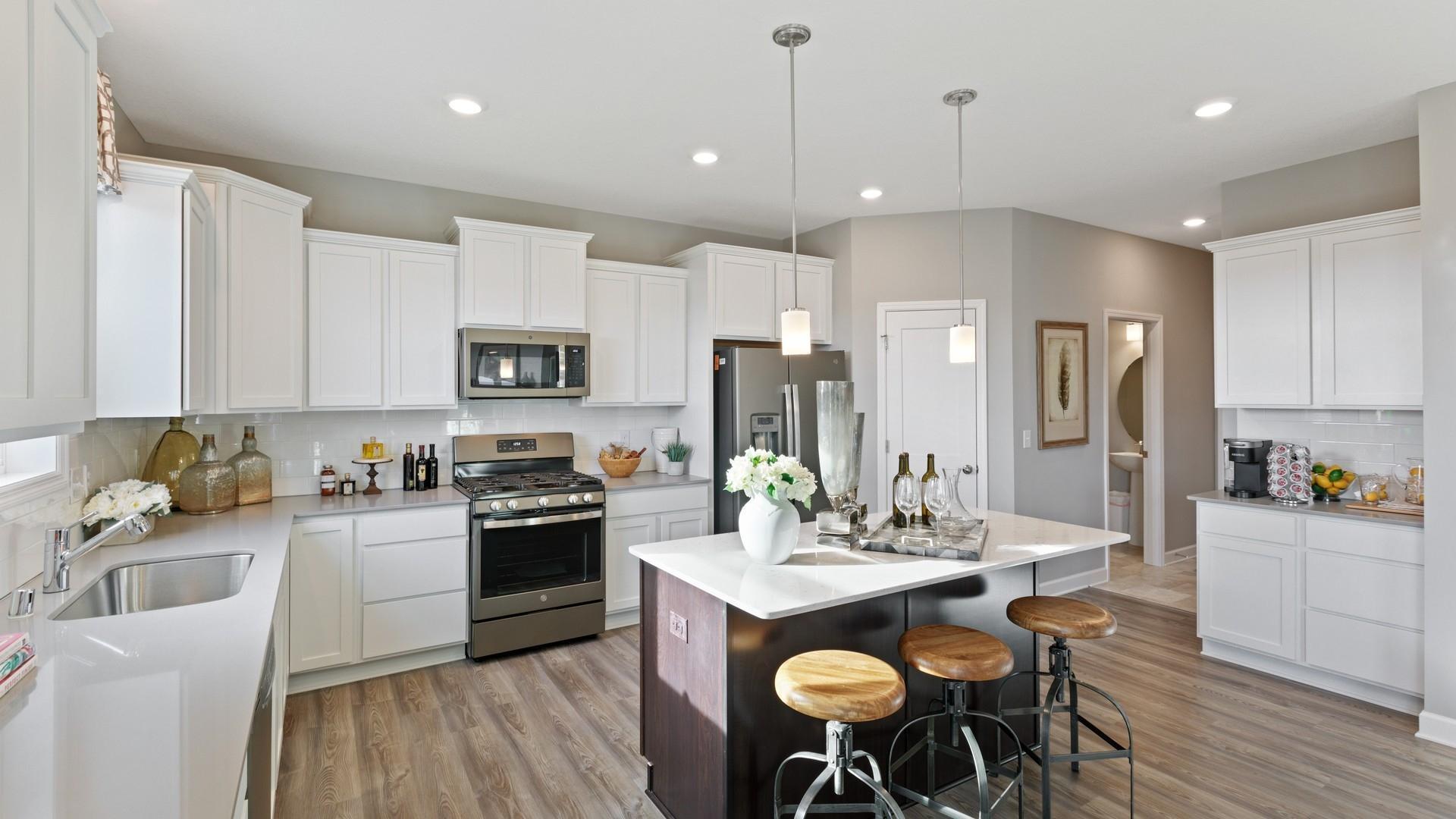 (Photo of decorated model, colors and features will vary) Thoughtfully designed kitchen with walls of cabinets and an abundance of storage.