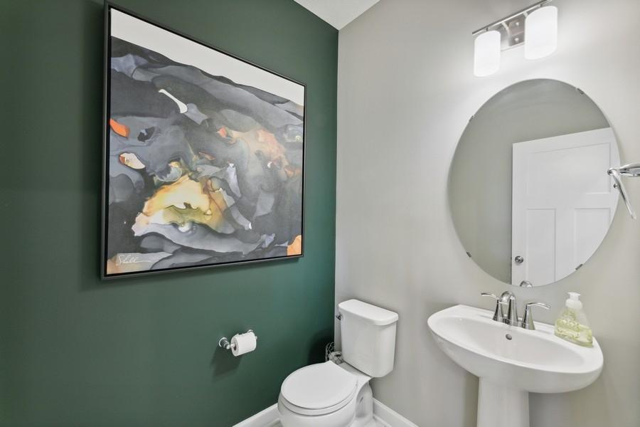 (Photo of decorated model, colors and features will vary) Powder bath conveniently located off the garage - no need to walk through the entire first level to reach this room.