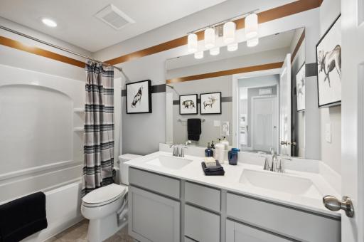 (Photo of model home, features will vary) This shared full bathroom features dual sinks and a shower-tub combination.
