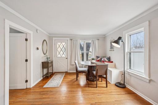 Foyer and dining space with built-in bench