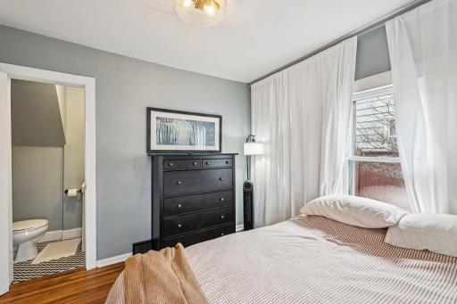 Main level bedroom with attached 1/2 bath