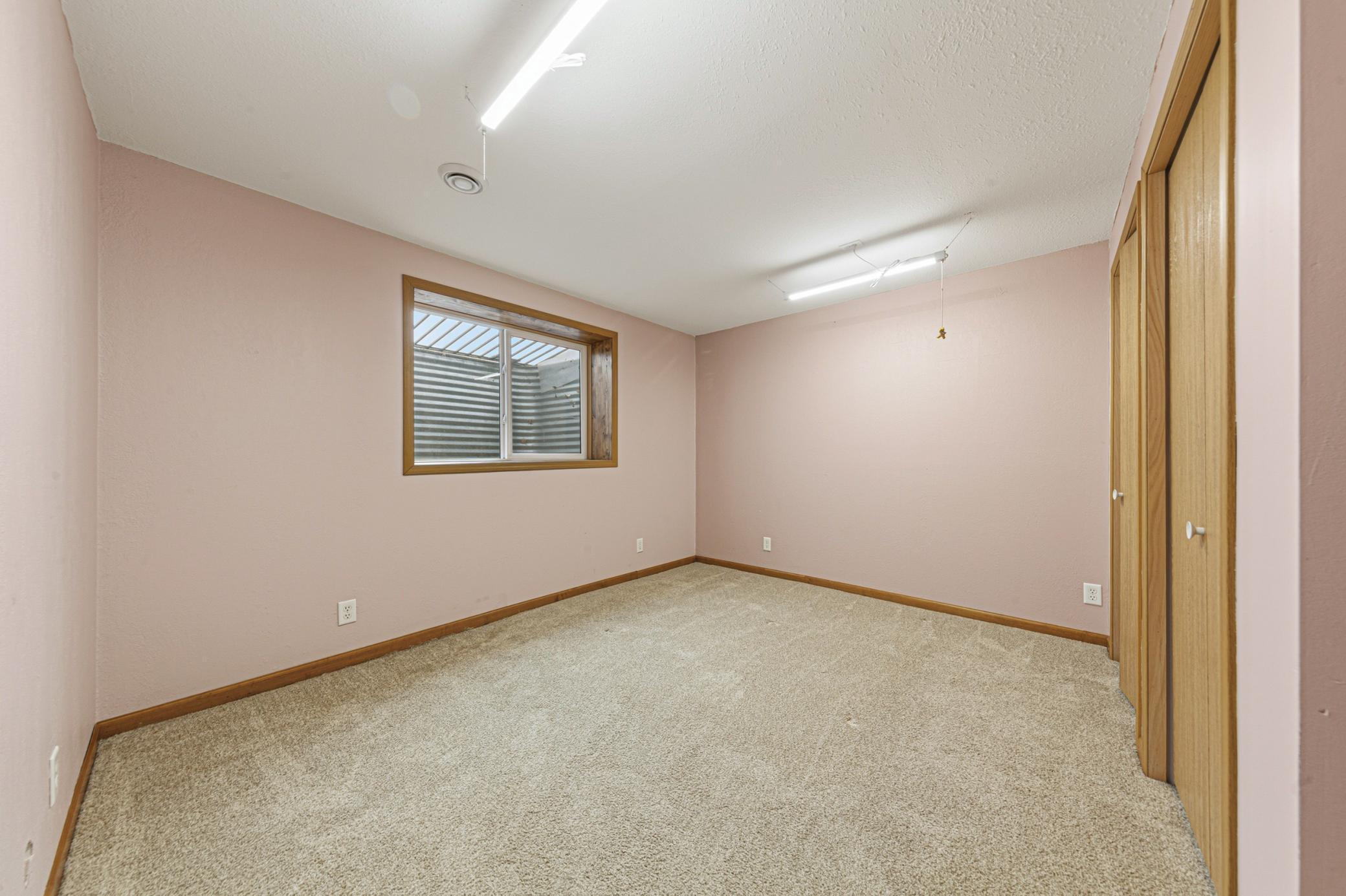 Lower level 3rd bedroom with egress window and double closets