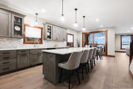 Thoughtfully designed with open sightlines and a seamless, flowing floor plan, the home is oriented to maximize coveted south-facing lake views throughout.