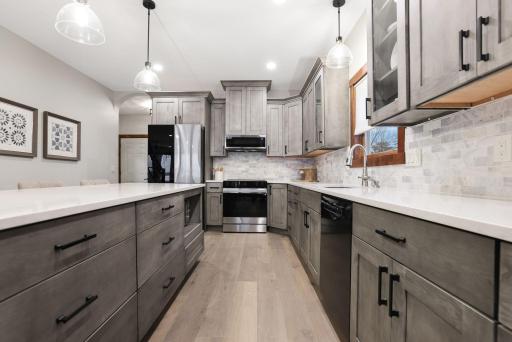 At the heart of the home, the chef’s kitchen (redone in 2024) blends style and function with high-end stainless steel appliances and a sleek tile backsplash.