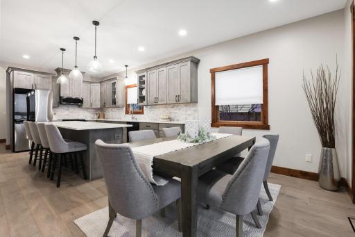 The adjoining dining area offers walkout access to a maintenance-free deck, creating effortless indoor-outdoor living, ideal for entertaining.