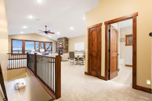 Upstairs, an expansive living space with vaulted ceilings includes a warm and inviting family room.