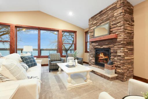 Enjoy a cozy gas fireplace, floor-to-ceiling windows, and walkout access to a maintenance-free deck with stunning sunset views.