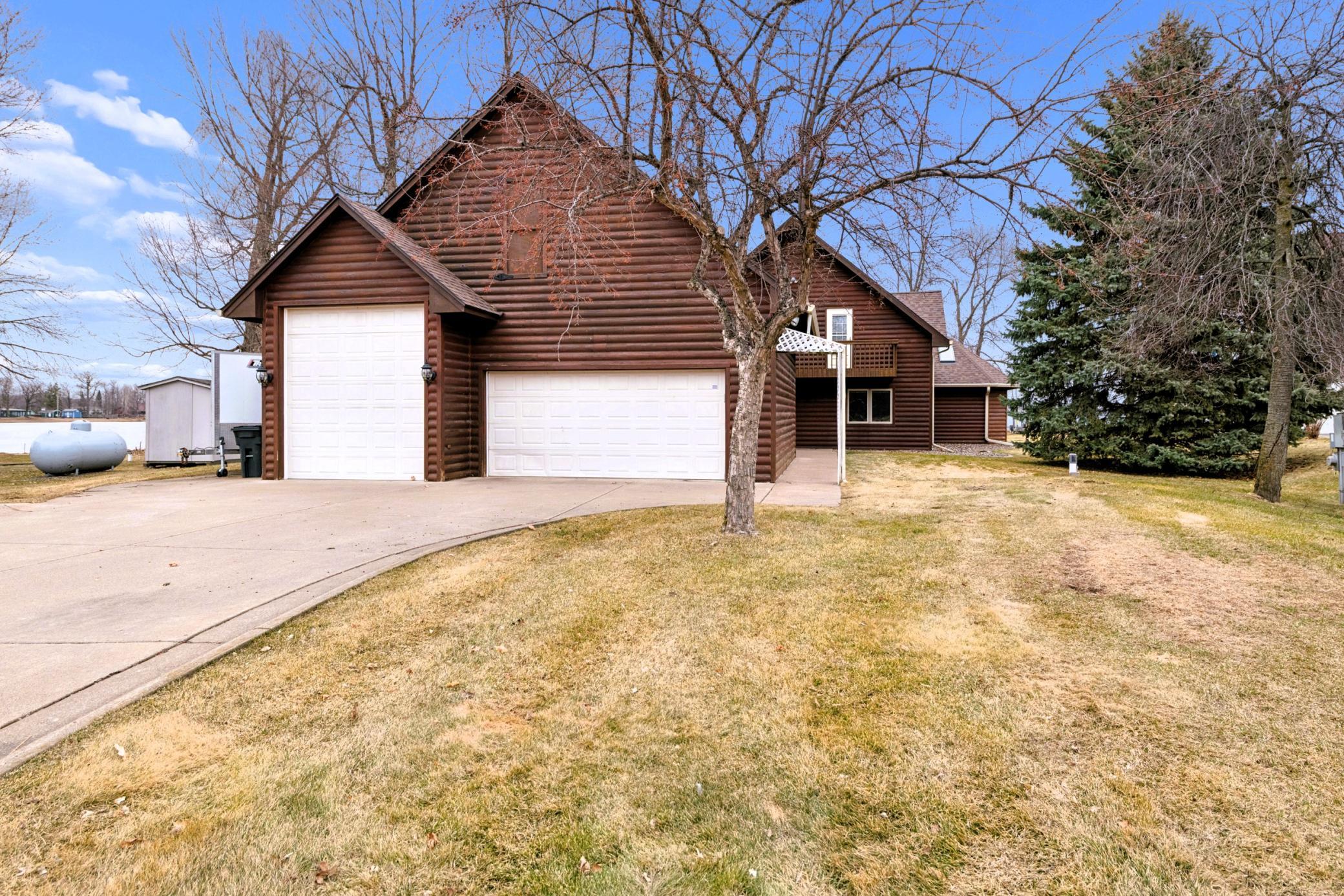 Detached insulated heated 3-car garage with 3rd stall high door for easy boat storage.