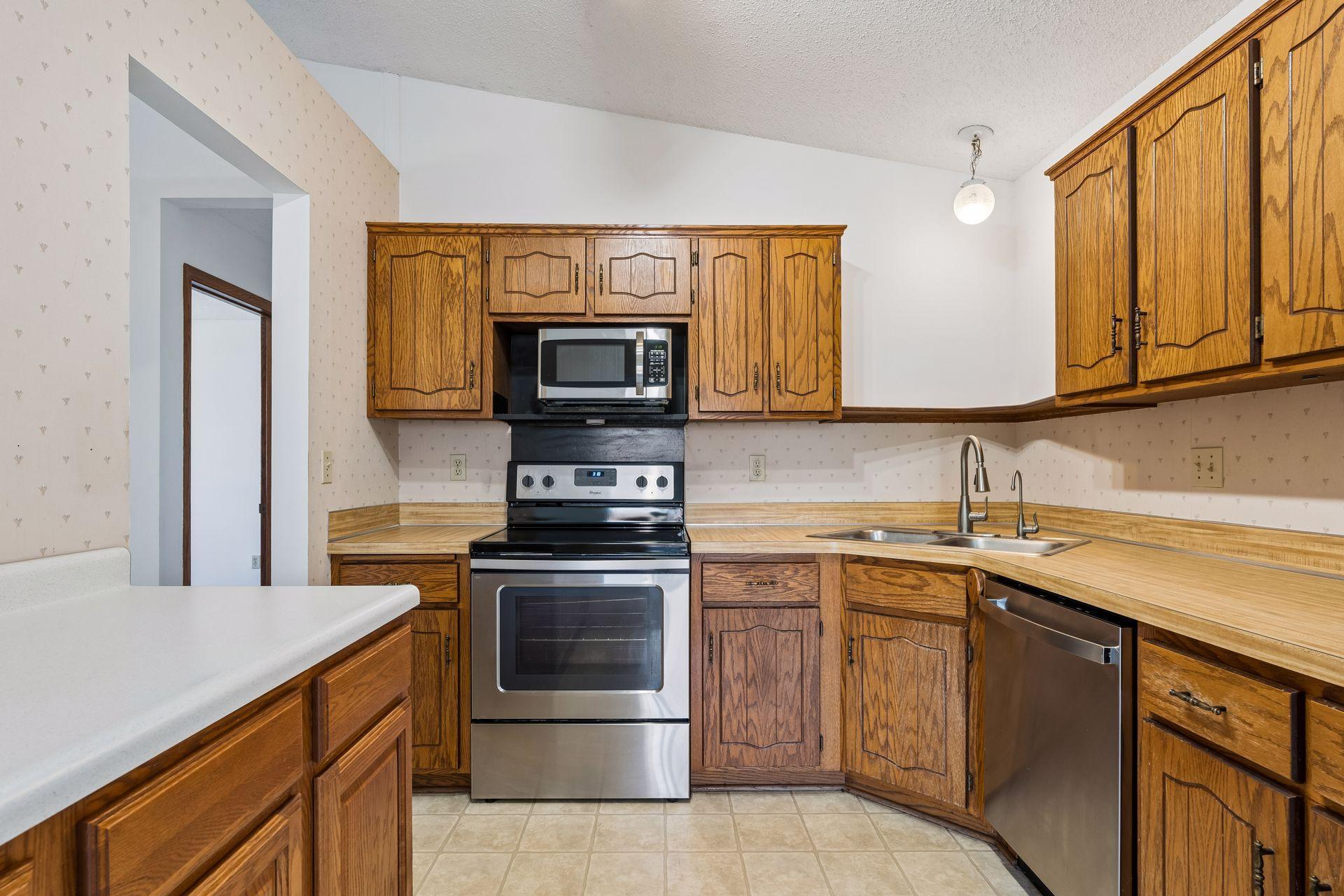 The kitchen features stainless steel appliances, perfect for everyday living and entertaining.
