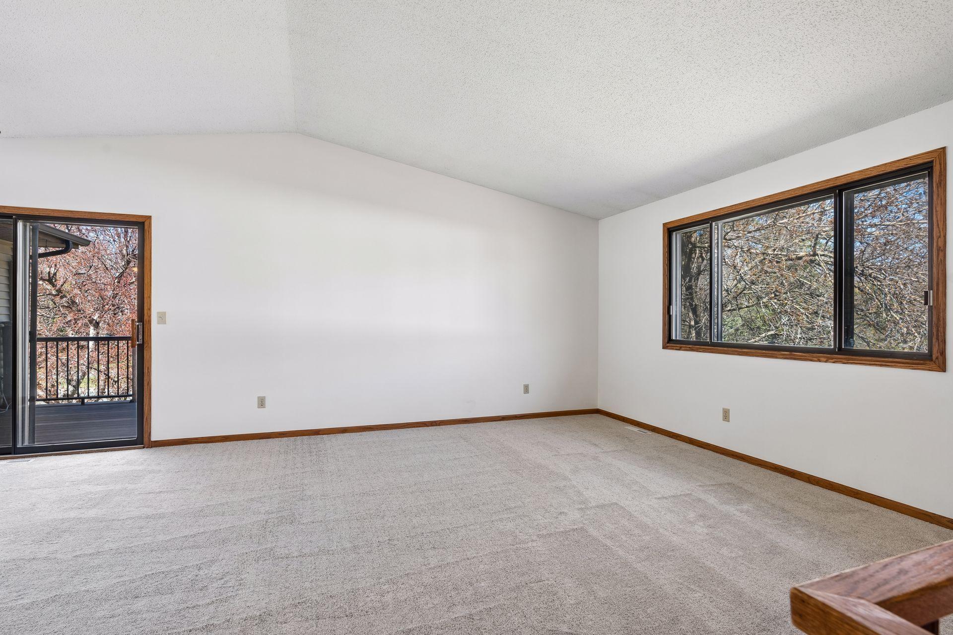 Spacious Living Room has fresh paint and new carpet.