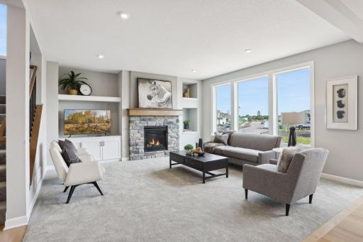 The living room on the main floor has a beautiful gas fireplace and wall built-ins. (Photo of a previously built Summit Floorplan)