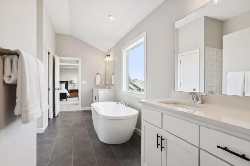 The luxurious, private bath comes with a freestanding tub. (Photo of a previously built Summit Floorplan)