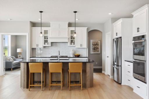 Our gourmet kitchen defines how the WOW comes standard. With a huge center island, granite countertops, gas cook top, and double ovens, plus so much more! (Photo of a previously built Summit Floorplan)