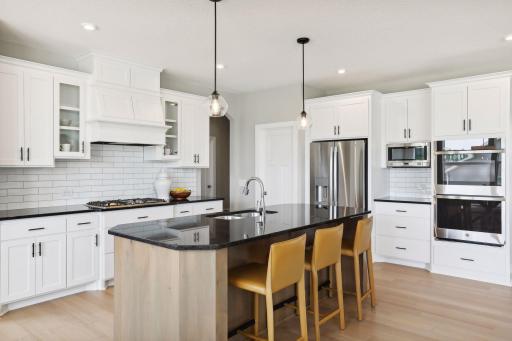 All our features are standard including the granite countertops, tile backsplash and under mount kitchen sinks. (Photo of a previously built Summit Floorplan)
