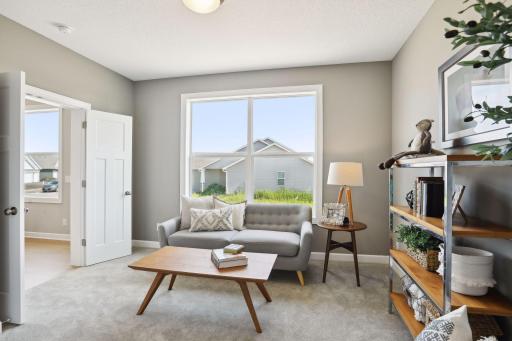 Just off the kitchen is the sun room. Use it as a reading nook or a place for your kids to play. (Photo of a previously built Summit Floorplan)
