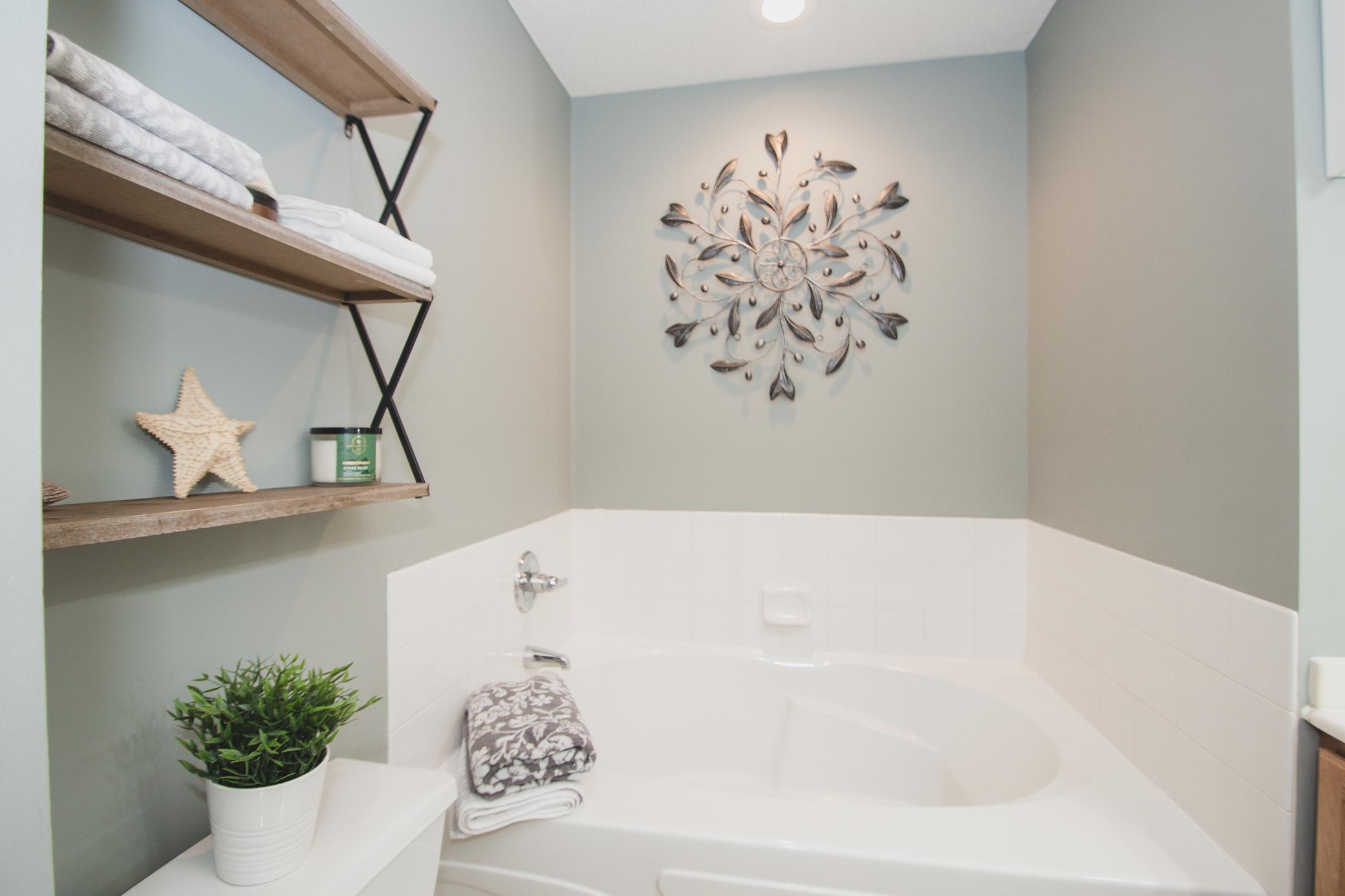 Full bath with soaking tub, separate shower, double sinks, and fresh paint (2025)