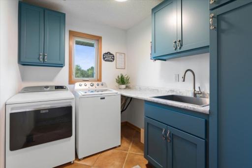 Even the laundry room has opinions. Teal cabinetry, and enough charm to make you almost enjoy laundry. Almost.