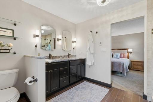 Dark cabinetry, marble counters, and lighting that flatters everyone.