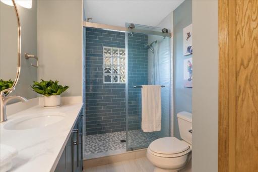 Walk-in shower, clean tile work, and the kind of finish that makes getting ready feel like a spa morning.