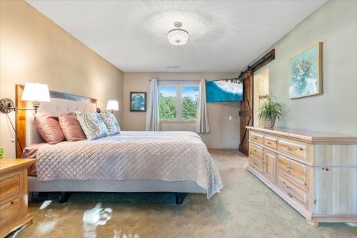 The barn door. The light. The space. The primary bedroom at 1200 Game Farm Circle does not miss.