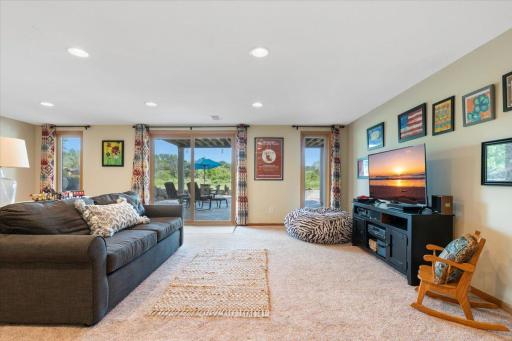 Lower level family room, walkout doors to patio, large windows, cozy seating "The lower level that doesn't feel like a lower level. Walkout access, natural light, and room to spread out.