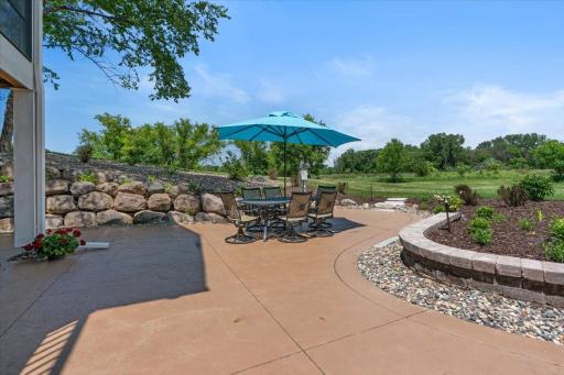 The stamped concrete patio where the evenings happen. Fire pit, open sky, and just under six acres of quiet in every direction.