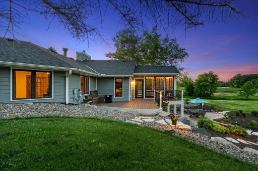 Warm glowing windows, three-season porch lit up, patio...choosing between inside and outside is difficult!