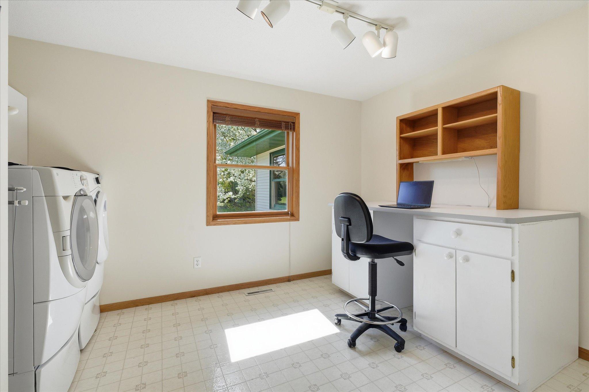 Currently used as a laundry room and office, this flexible main-floor space can easily be converted back into a bedroom to suit your needs.