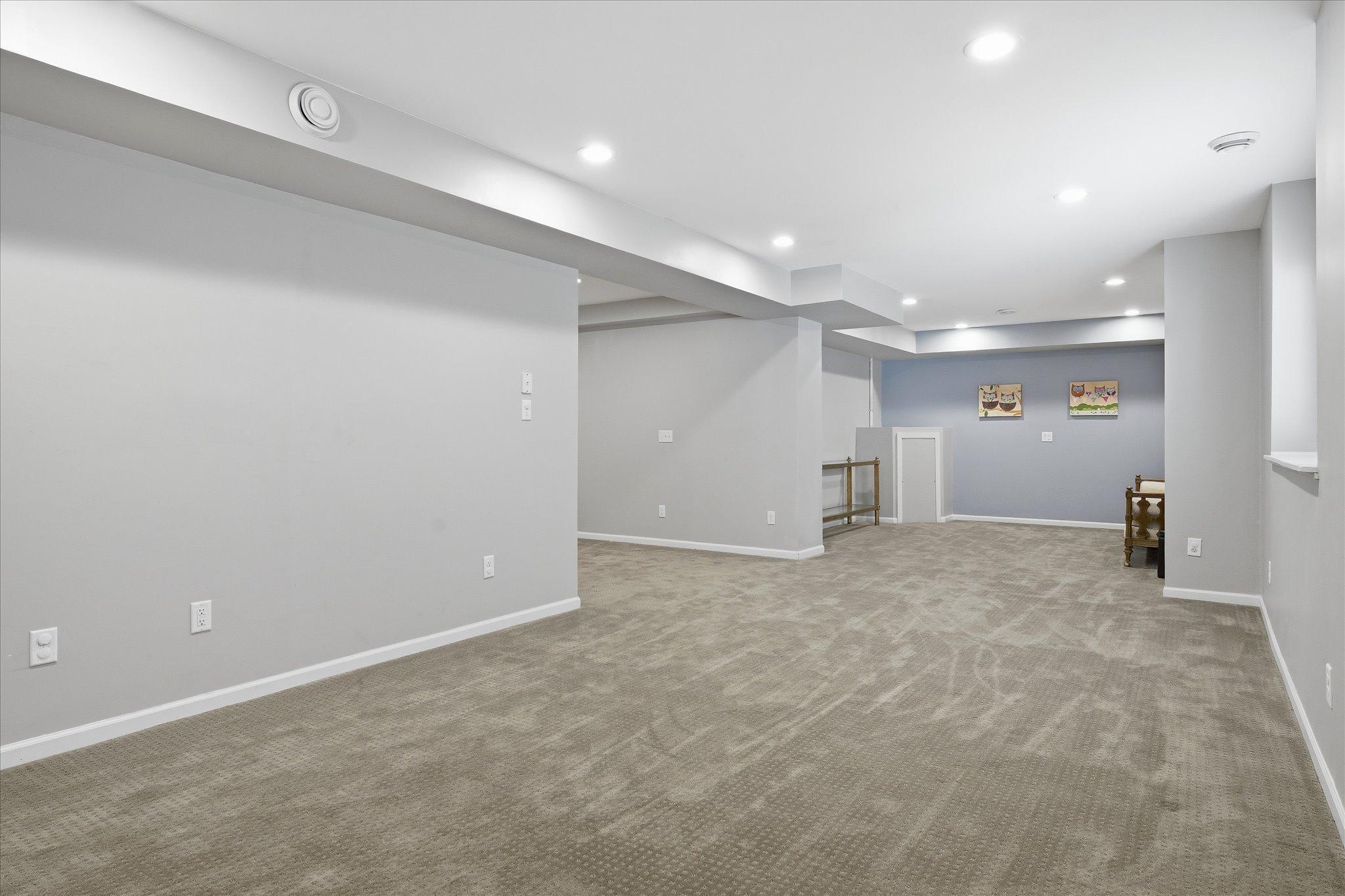 The expansive lower-level layout creates flexibility for recreation, game nights, or additional lounge areas, making it a true extension of the home.