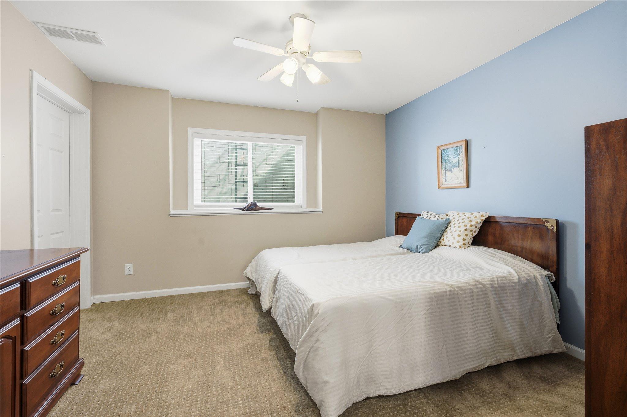 The lower-level bedroom offers privacy and comfort, making it ideal for guests, family members, or a private retreat.