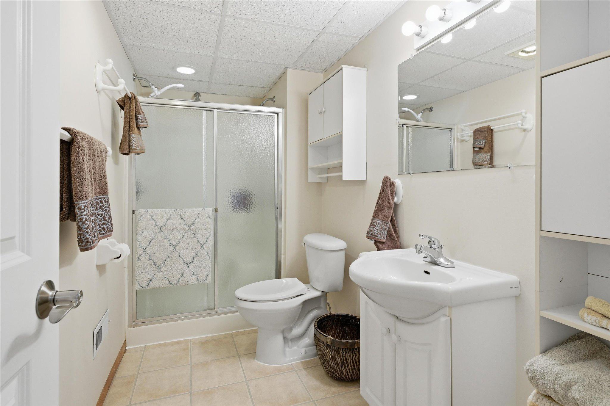 The lower-level 3/4 bathroom adds comfort and convenience for guests or extended living arrangements within the lower level.