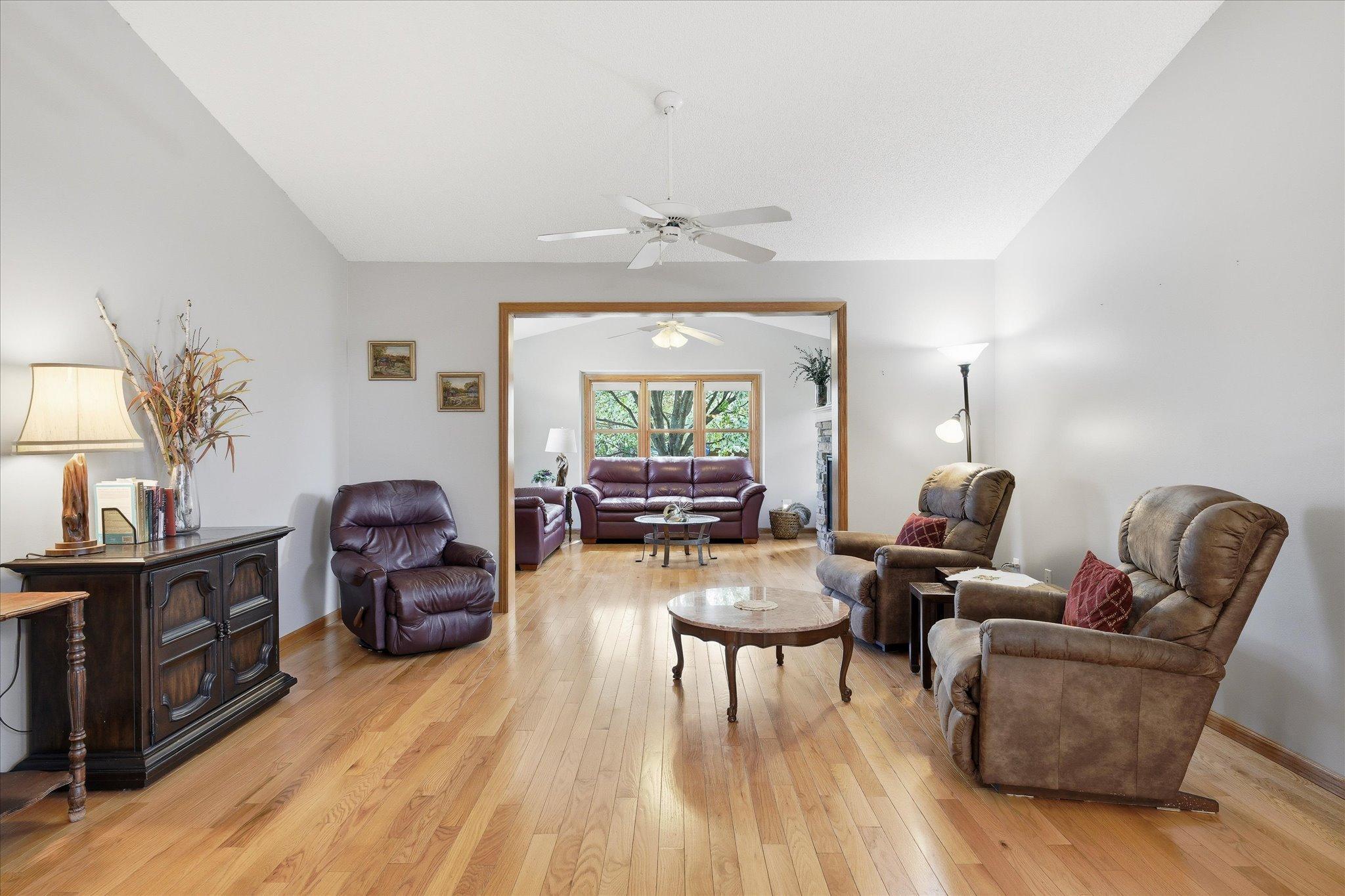 Beautiful hardwood floors add warmth and elegance to the living room, enhancing the bright and welcoming atmosphere throughout the main level.