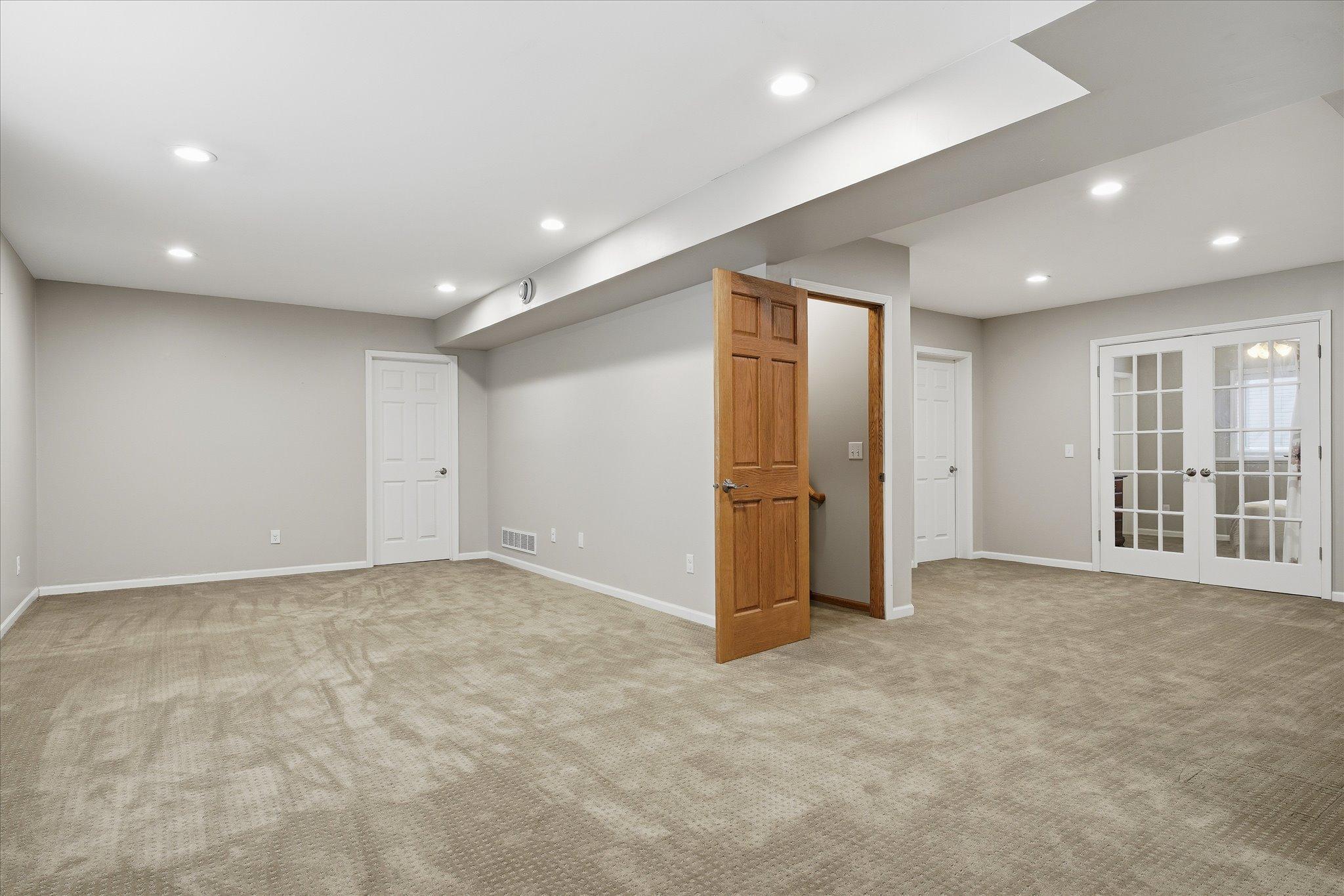 The spacious lower-level family room is ready for your personal touch, offering endless possibilities for entertainment, relaxation, or hobbies.
