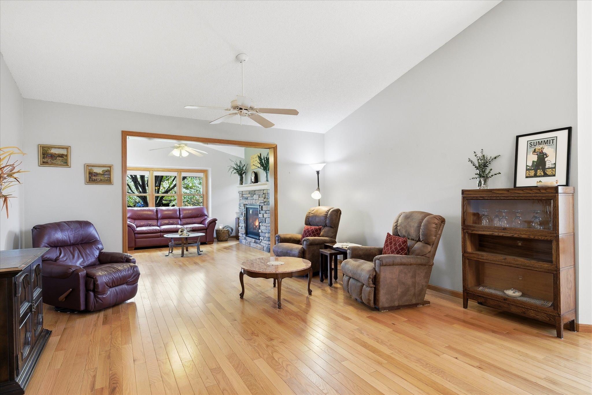 The living area flows beautifully into the nearby sunroom, creating a comfortable and connected space for relaxing or entertaining guests.