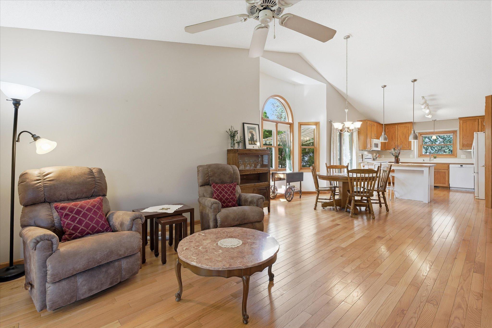 The open-concept layout seamlessly ties together the living room, dining area, kitchen, and sunroom, creating a home that feels spacious and inviting.