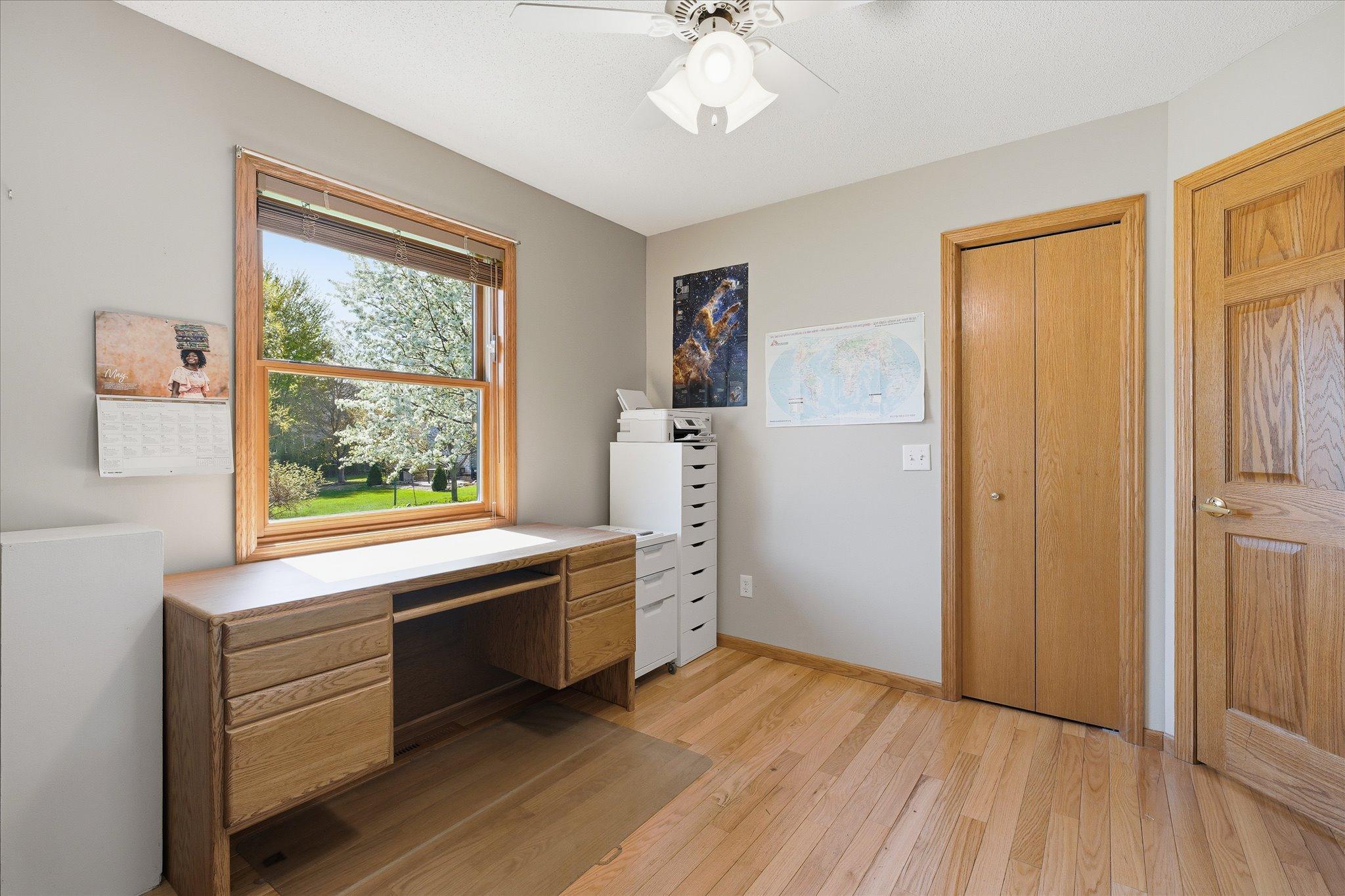 A large window fill the second bedroom with natural light while offering pleasant neighborhood views.