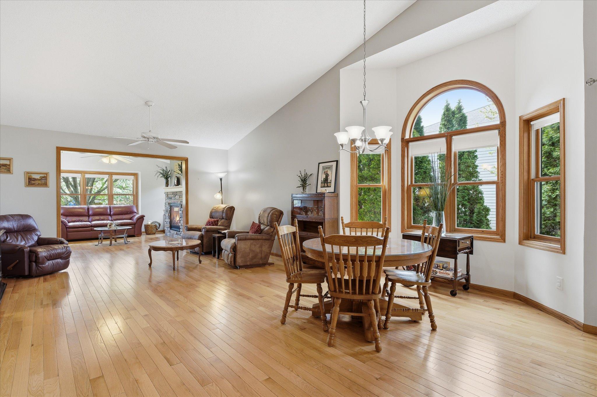 Natural light pours through the home, highlighting the open floor plan connecting the living room, dining area, and sunroom.