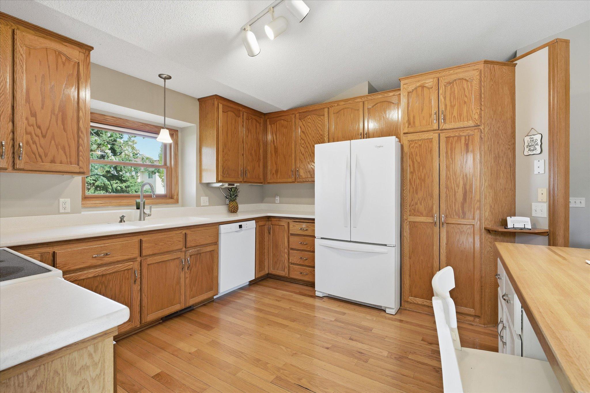 Abundant cabinetry and wide countertops provide excellent storage and workspace for cooking and organization.