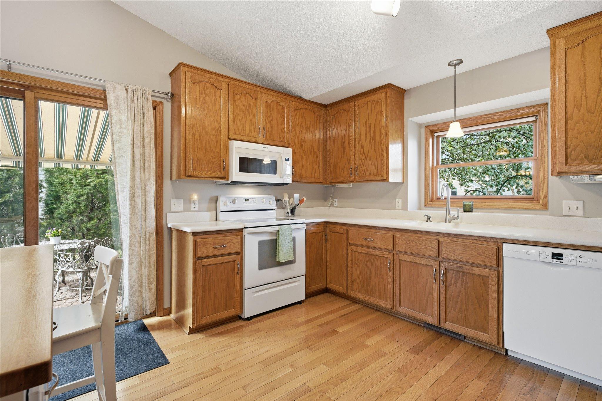 Abundant cabinetry and wide countertops provide excellent storage and workspace for cooking and organization.