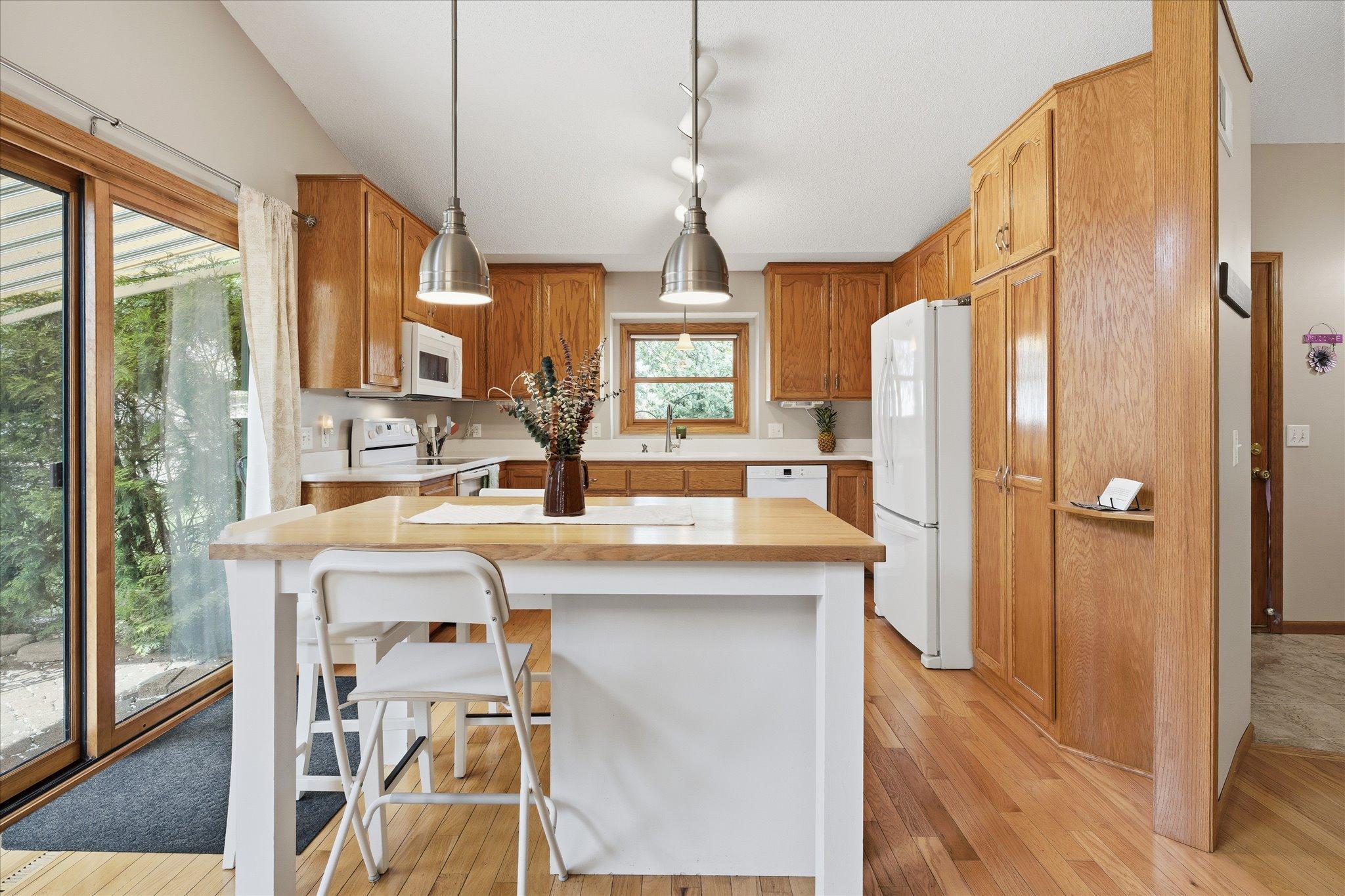 A center island adds extra prep space and casual seating, making the kitchen ideal for meal prep and entertaining.