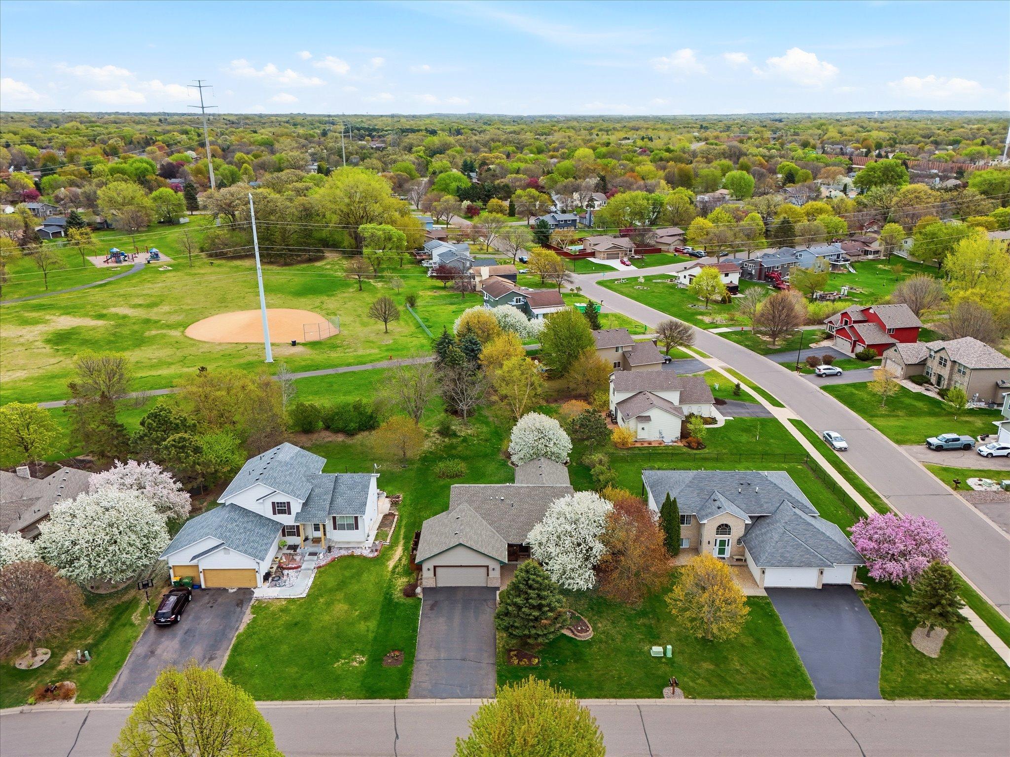 An aerial perspective highlights the home’s exceptional location backing directly to Royal Oaks Park, with trails and green space just steps away.