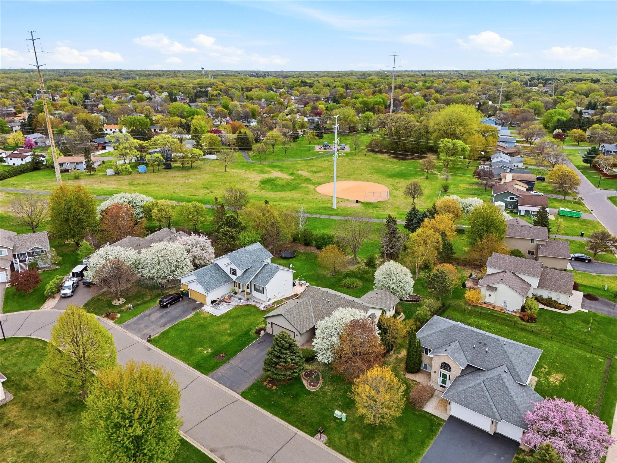 An aerial perspective highlights the home’s exceptional location backing directly to Royal Oaks Park, with trails and green space just steps away.