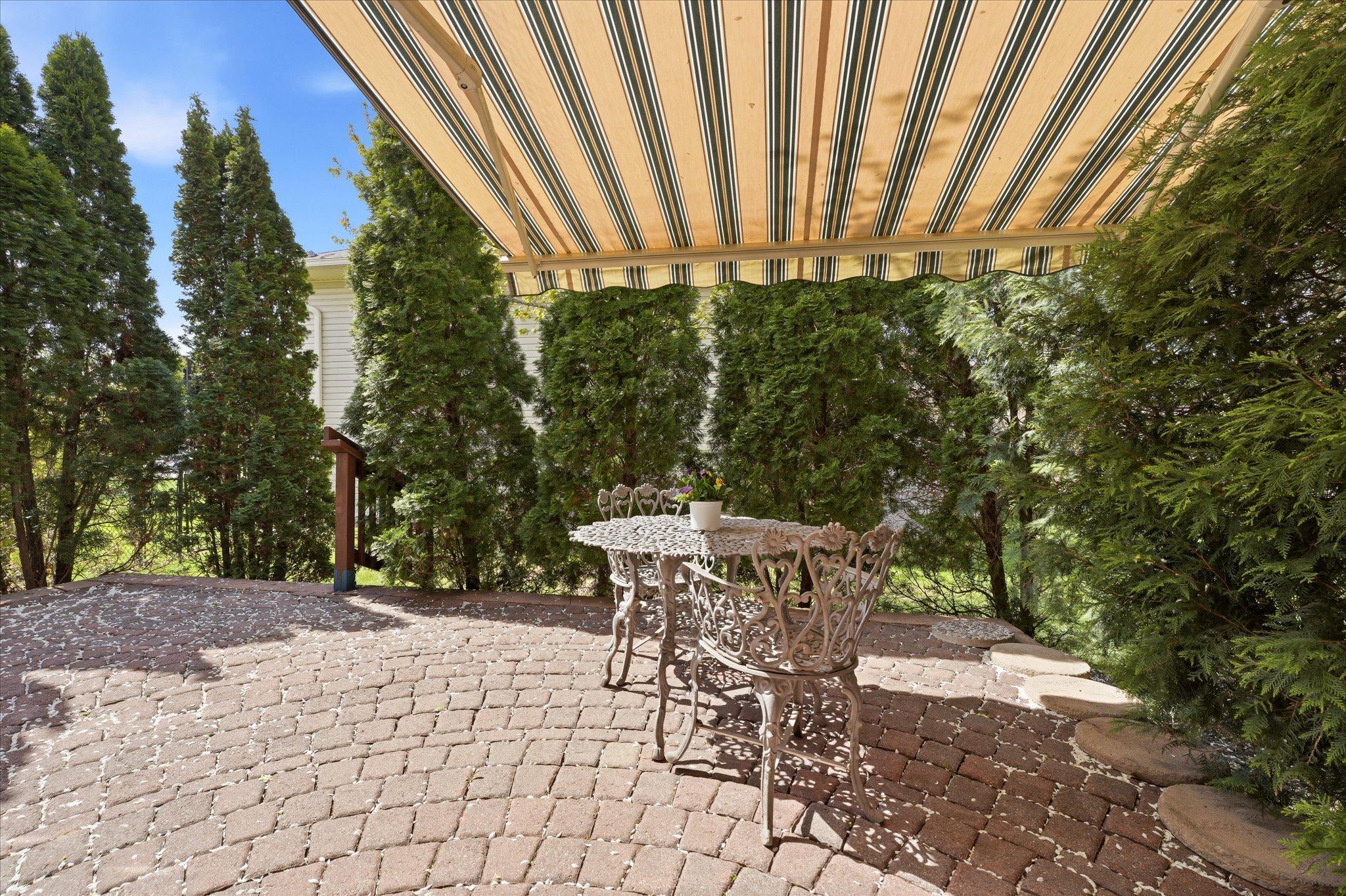 Enjoy peaceful mornings or relaxing afternoons on the paver patio, complete with a private setting surrounded by mature landscaping.