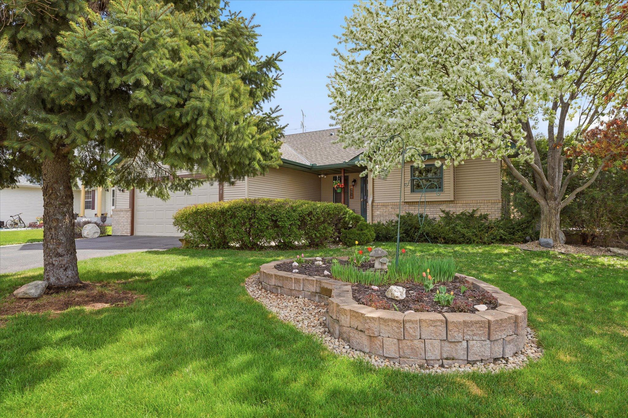 Well-maintained landscaping enhances the front exterior, creating a welcoming first impression filled with charm and character. The mature greenery adds privacy and highlights the home’s beautiful setting.