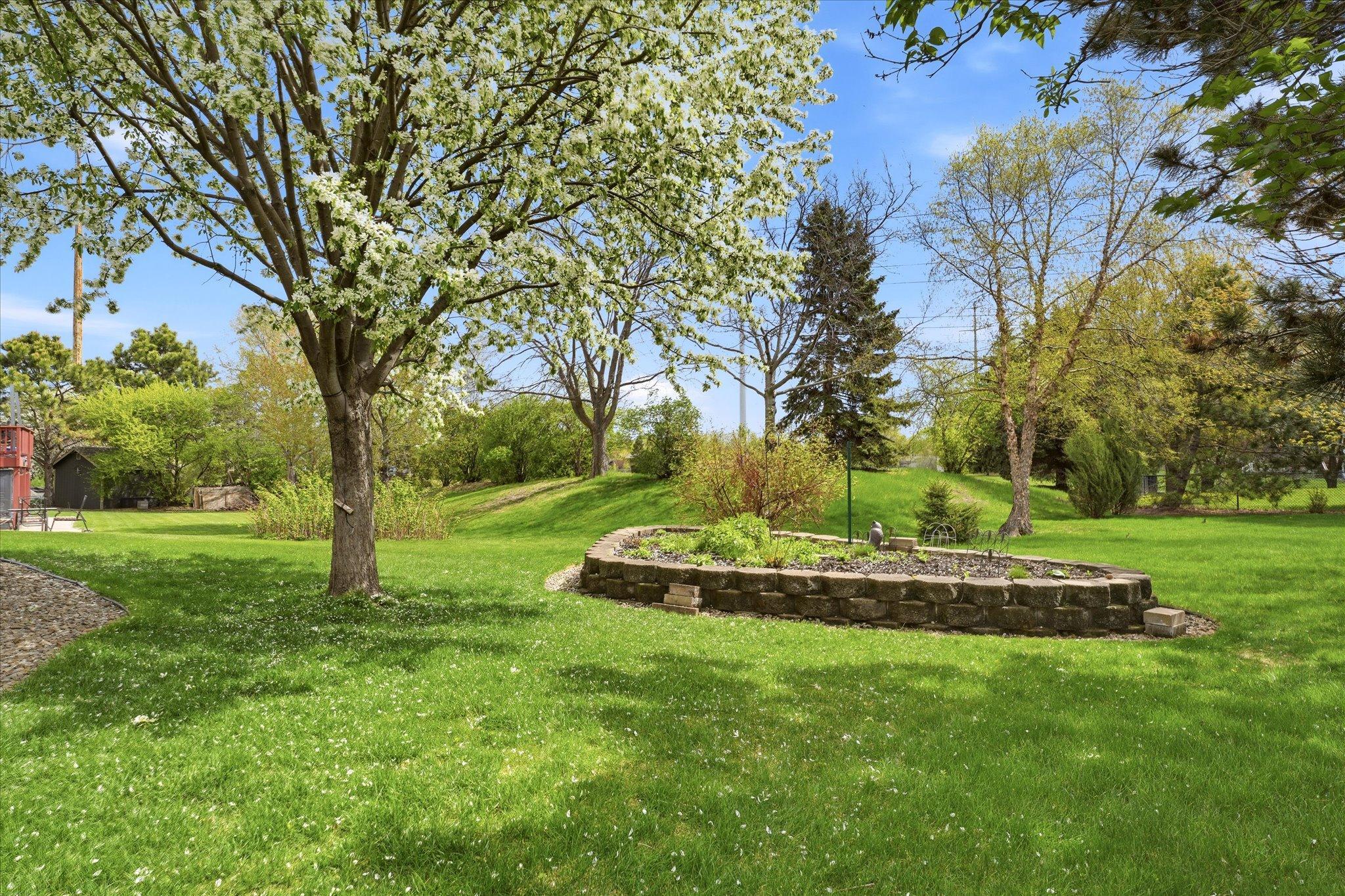 Thoughtfully designed landscaping creates a peaceful backyard retreat filled with greenery, color, and privacy.