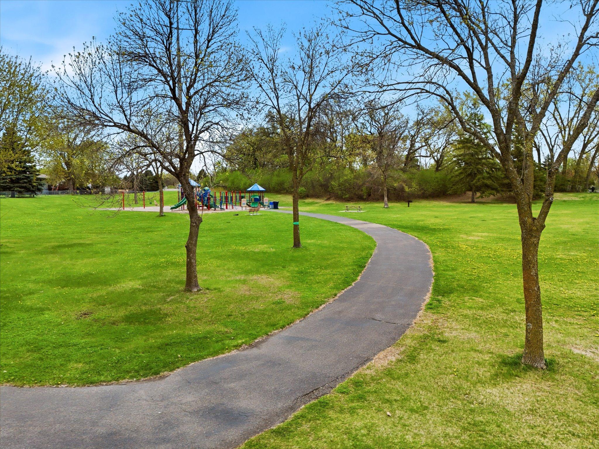 Enjoy direct trail access leading across Highway 610 to Edinbrook Park, connecting you to miles of outdoor recreation and scenic walking paths.